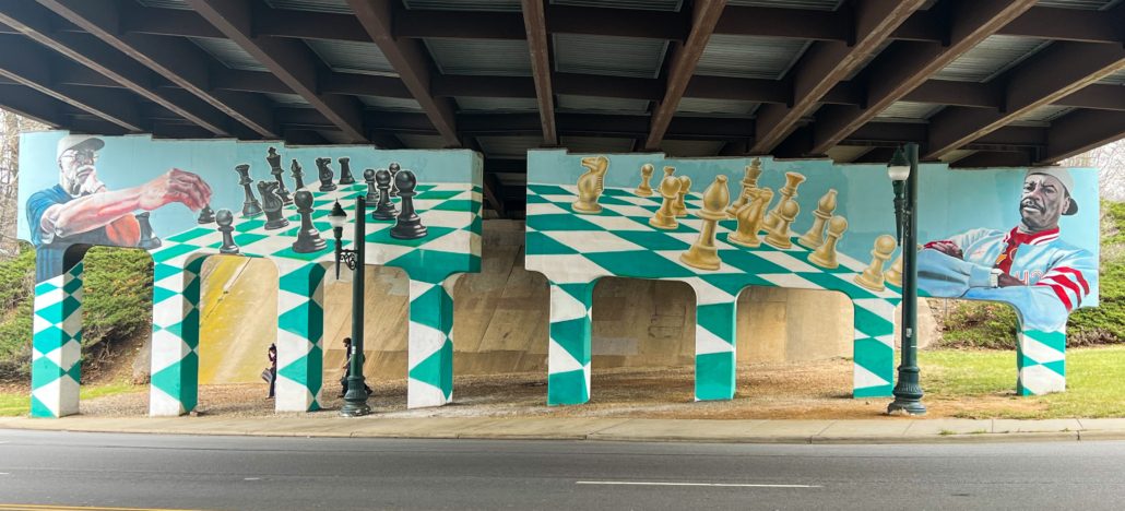 A mural of two men playing chess. Asheville Vacation Rental