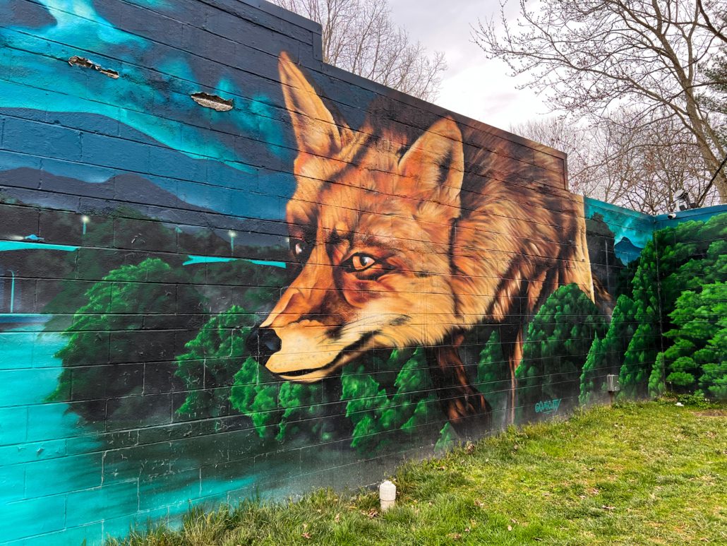 A mural of a fox in the forest Asheville Vacation Rental